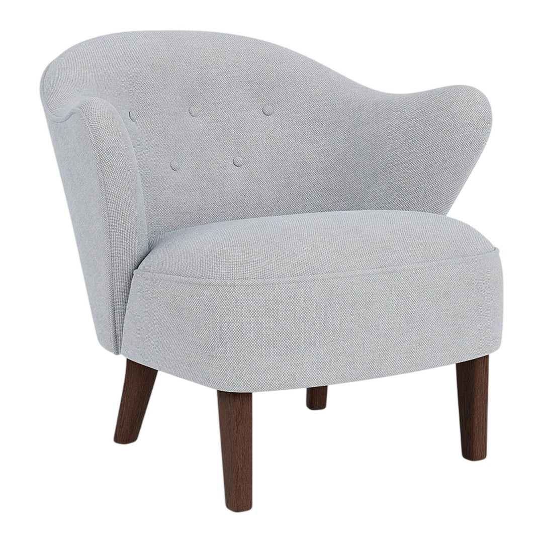 Gray upholstered accent chair with a curved back and button tufting, complemented by wooden legs.