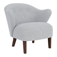 Gray upholstered accent chair with a curved back and button tufting, complemented by wooden legs.