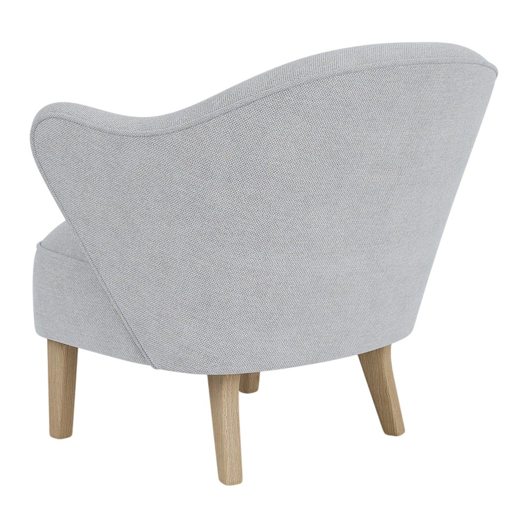 Light gray upholstered chair with a curved back and natural wood legs, featuring a smooth, textured surface.