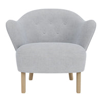 Stylish light gray chair with a curved back, button detailing, and natural wooden legs. Modern and cozy design.