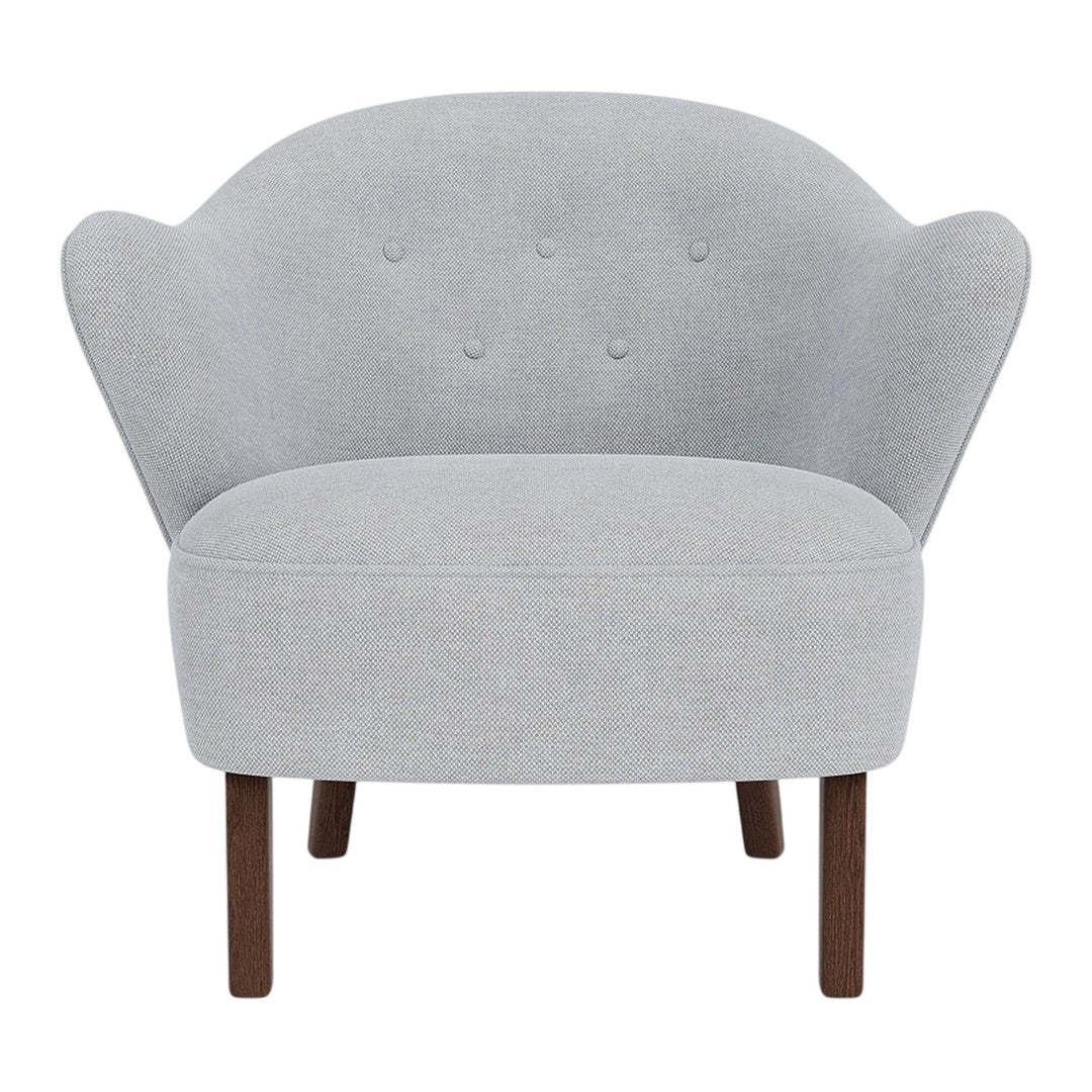 Light gray upholstered chair with a curved back, subtle button detailing, and wooden legs. Ideal for modern decor.