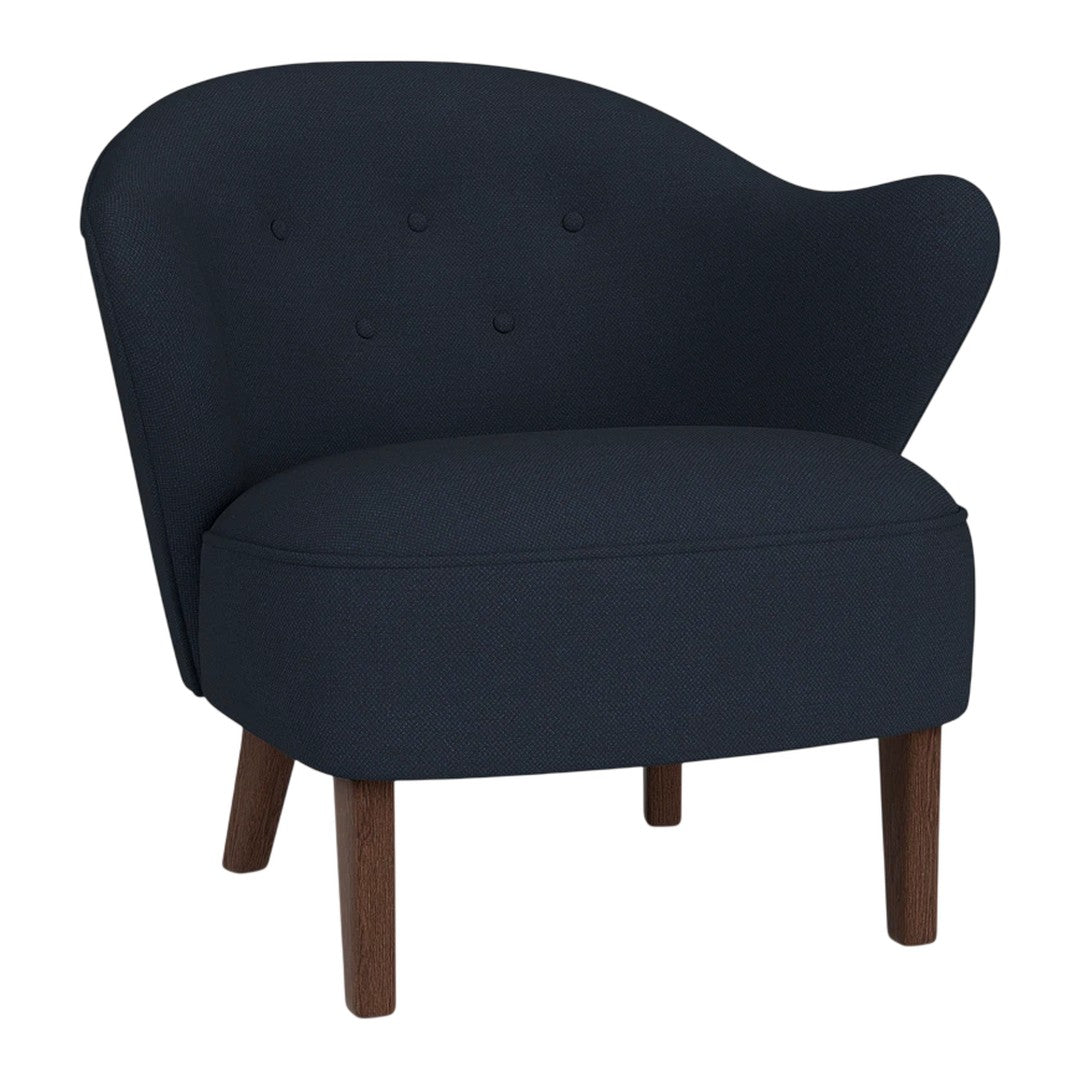 Navy blue upholstery with button-tufted pattern and wooden legs, featuring a modern curved design.