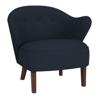 Navy blue upholstery with button-tufted pattern and wooden legs, featuring a modern curved design.