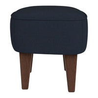 Navy blue upholstered ottoman with clean lines and dark wood legs, perfect for modern decor.