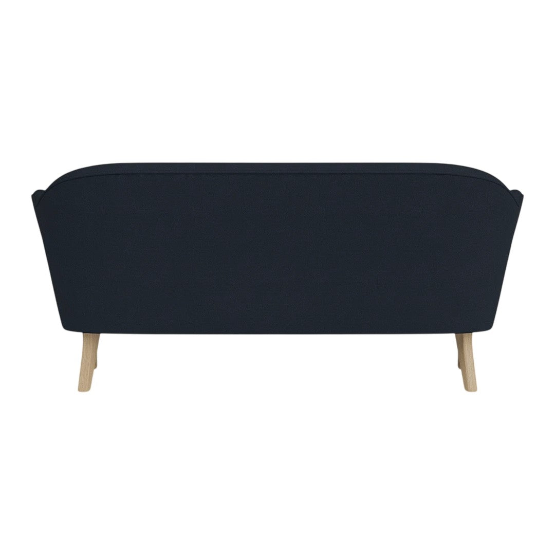 Navy blue sofa with a streamlined design and light wooden legs, perfect for modern decor.