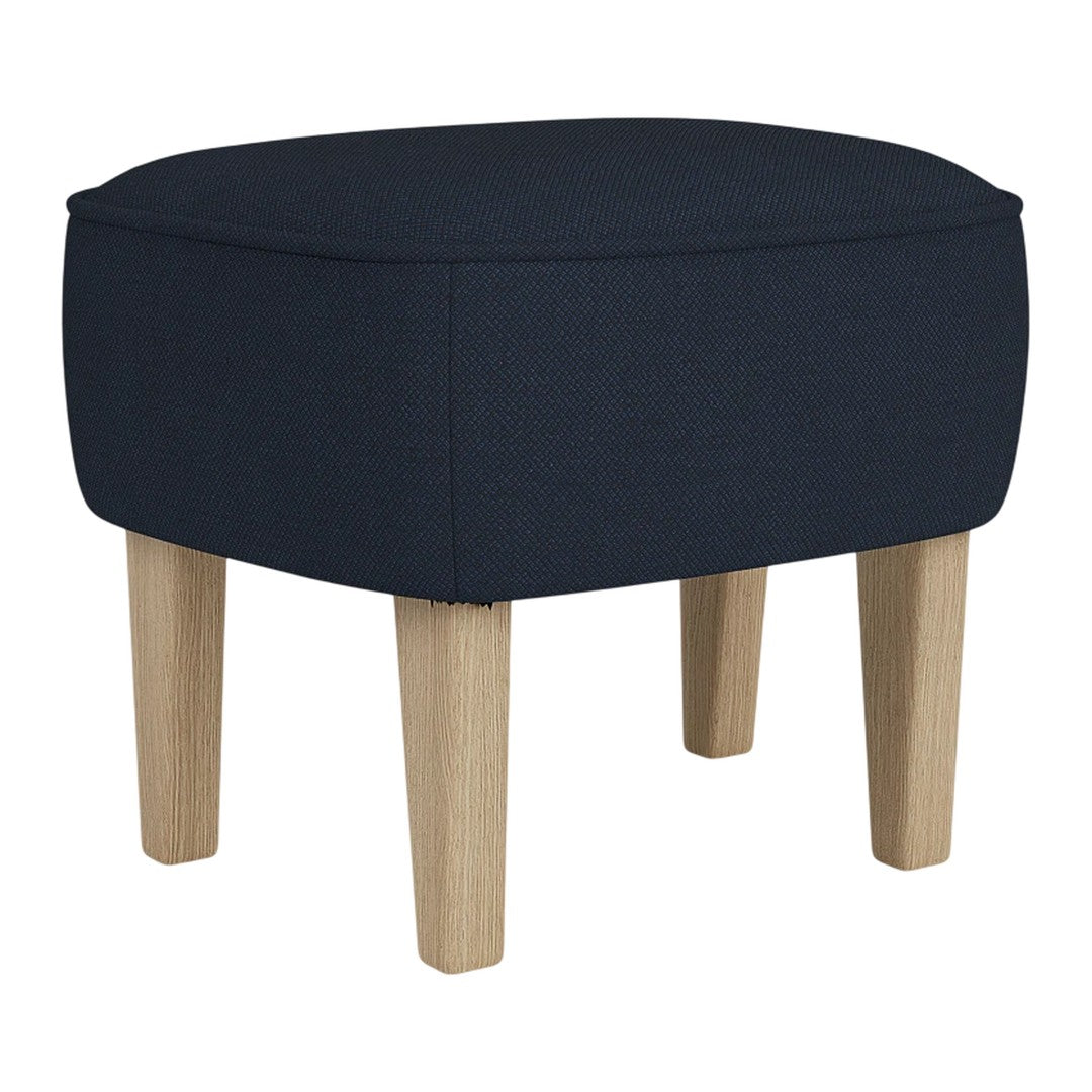 Navy blue upholstered stool with natural wood legs, smooth texture, and rounded design perfect for modern decor.
