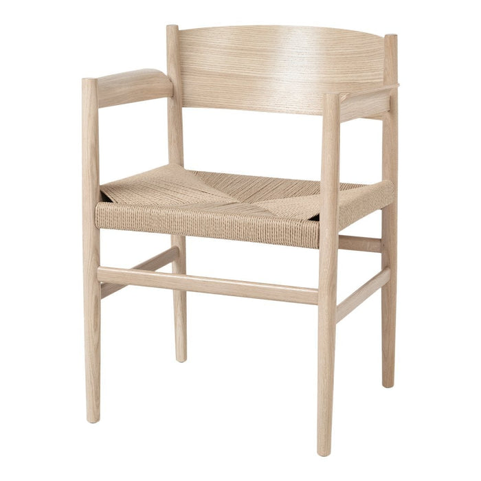Natural wood chair with a light finish and woven seat pattern, showcasing minimalist design and neutral tones.