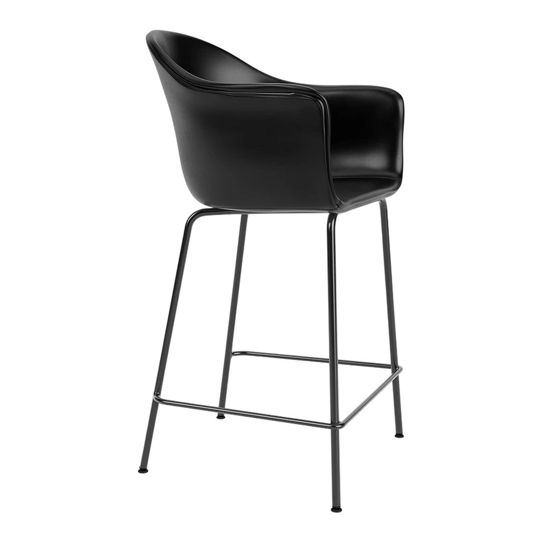 Black upholstered bar stool with a sleek contoured design and minimalist metal legs. Perfect for modern decor.