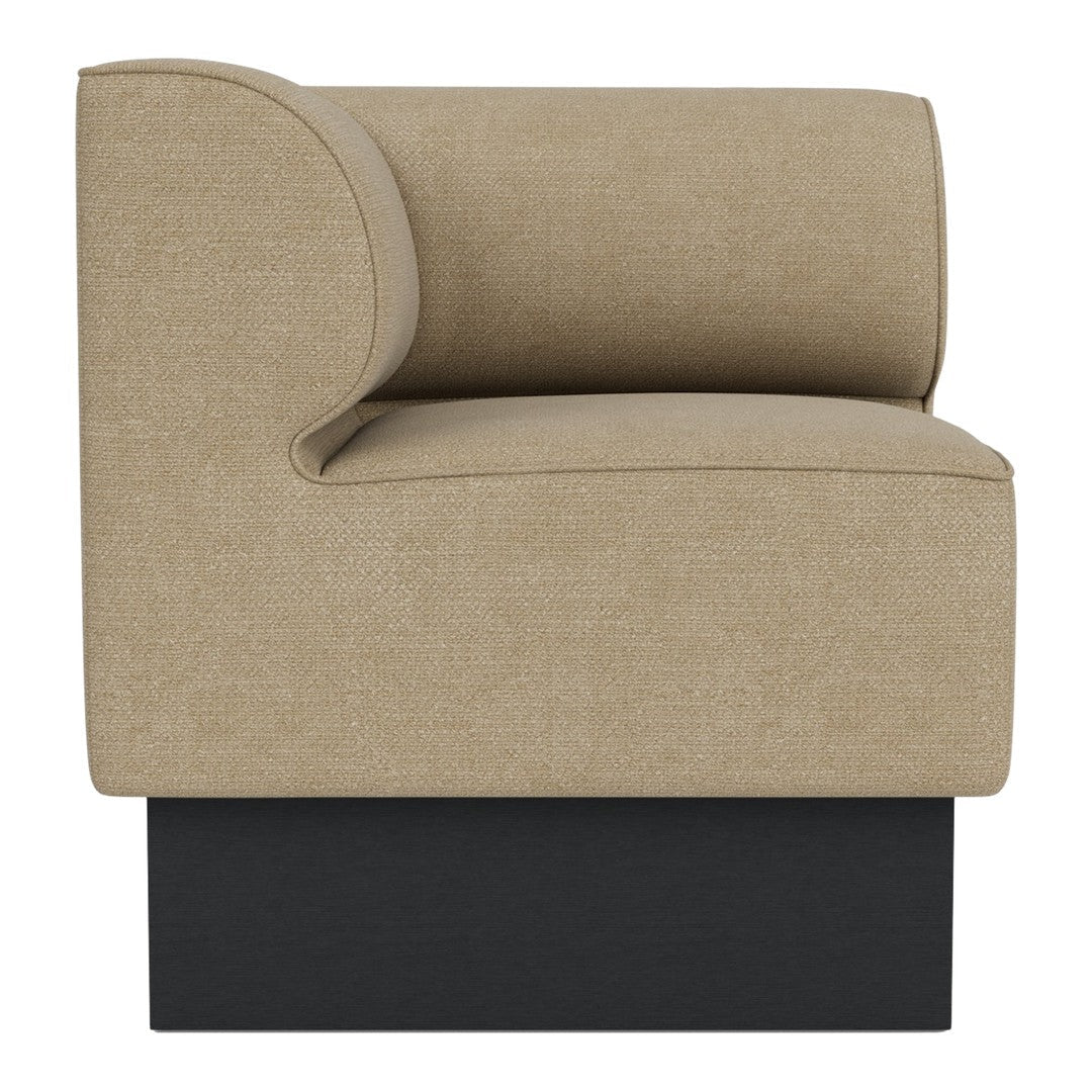 Beige fabric accent chair with a curved backrest and dark black base. Modern, minimalist design for contemporary decor.