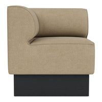 Beige fabric accent chair with a curved backrest and dark black base. Modern, minimalist design for contemporary decor.