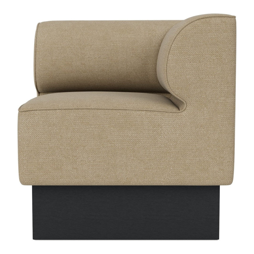 Beige fabric accent chair with a curved back and a sleek black base, adding modern elegance to any space.
