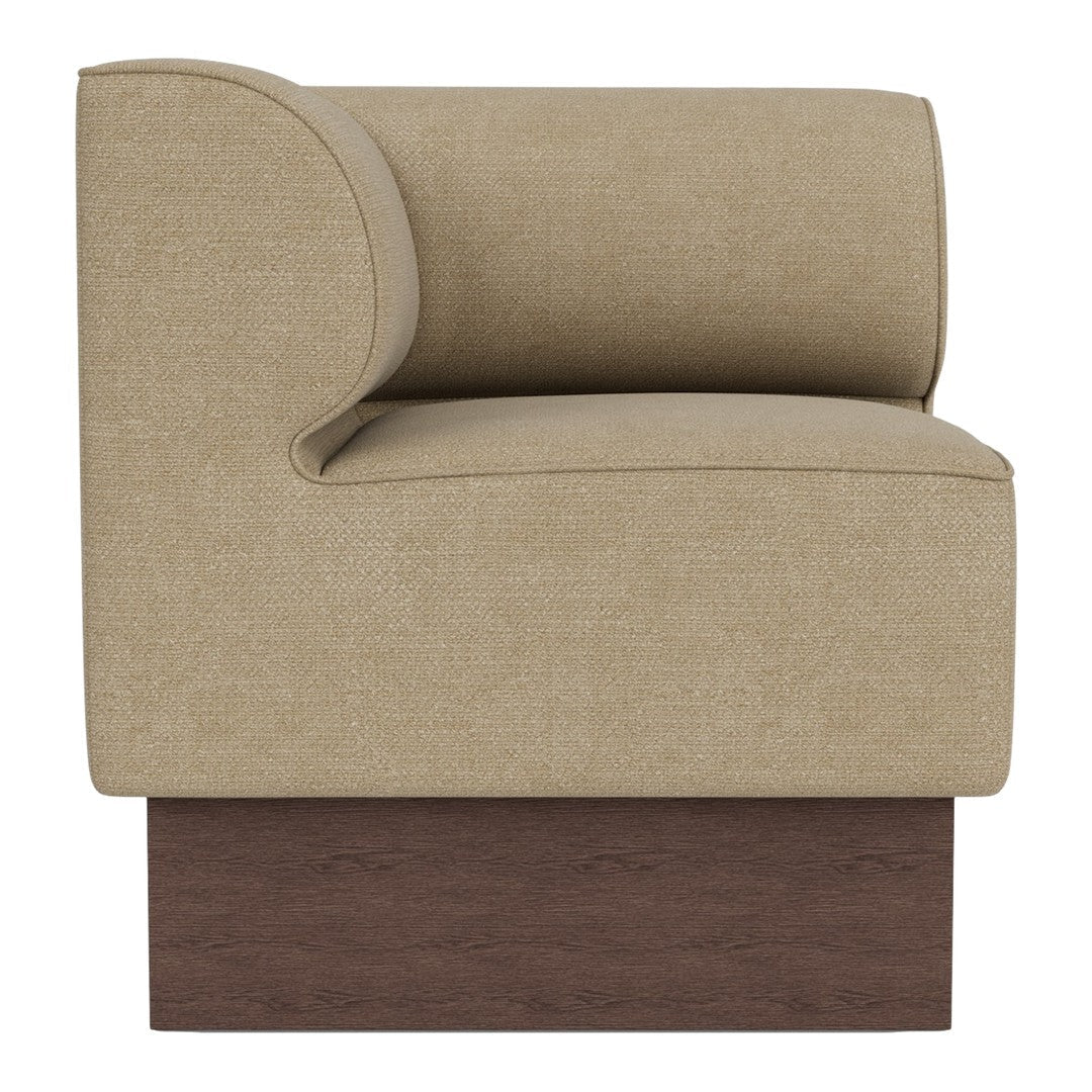 Beige upholstered armchair with curved backrest and dark wooden base, showcasing a smooth, minimalist design.
