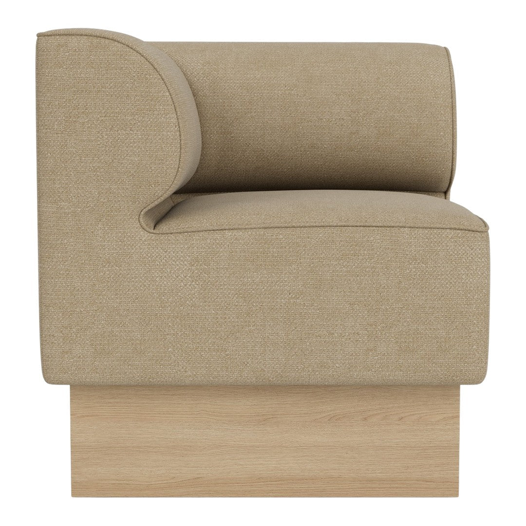 Beige upholstered armchair with a curved backrest and wooden base, showcasing a minimalist, modern design.