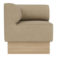 Beige upholstered armchair with a curved backrest and wooden base, showcasing a minimalist, modern design.