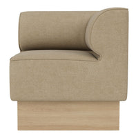 Beige upholstered chair with a smooth texture and rounded arm, balanced on a light wood base.