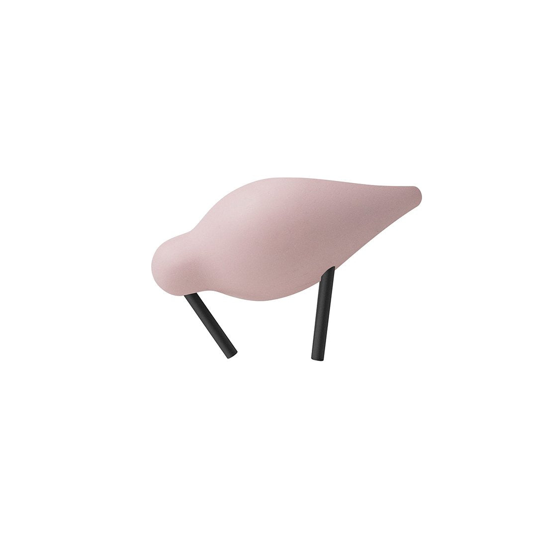 Pink bird figurine with smooth curves and contrasting black legs, perfect for home decor.