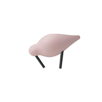 Pink bird figurine with smooth curves and contrasting black legs, perfect for home decor.