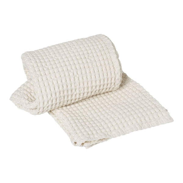 Woven cream-colored fabric roll with a textured, grid-like pattern, perfect for home decor or crafting projects.