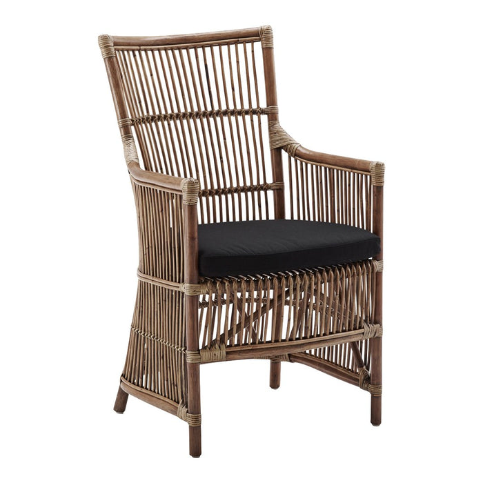Rattan armchair with a natural finish and black cushion, featuring a sleek vertical striped pattern.