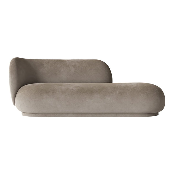 Soft beige chaise lounge with smooth, rounded edges and a minimalist design. Perfect for modern decor.