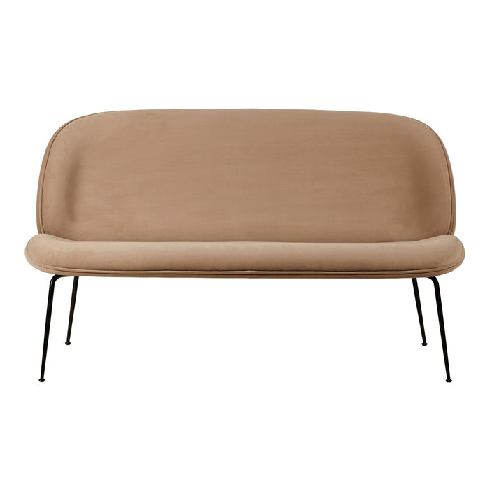Light beige upholstery sofa with smooth, rounded silhouette and sleek black metal legs. Perfect for modern decor.