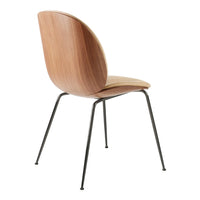 Modern wooden chair with a warm walnut finish and sleek black metal legs. Minimalist design with smooth curves.