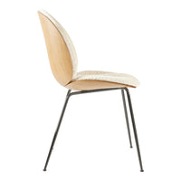 Beige upholstered seat with a natural wood back and sleek black metal legs. Modern and minimalist design.