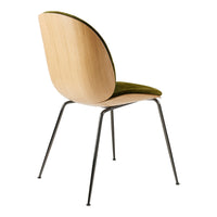 Wooden chair with a curved back, olive green velvet seat, and sleek black metal legs. Modern design with natural tones.