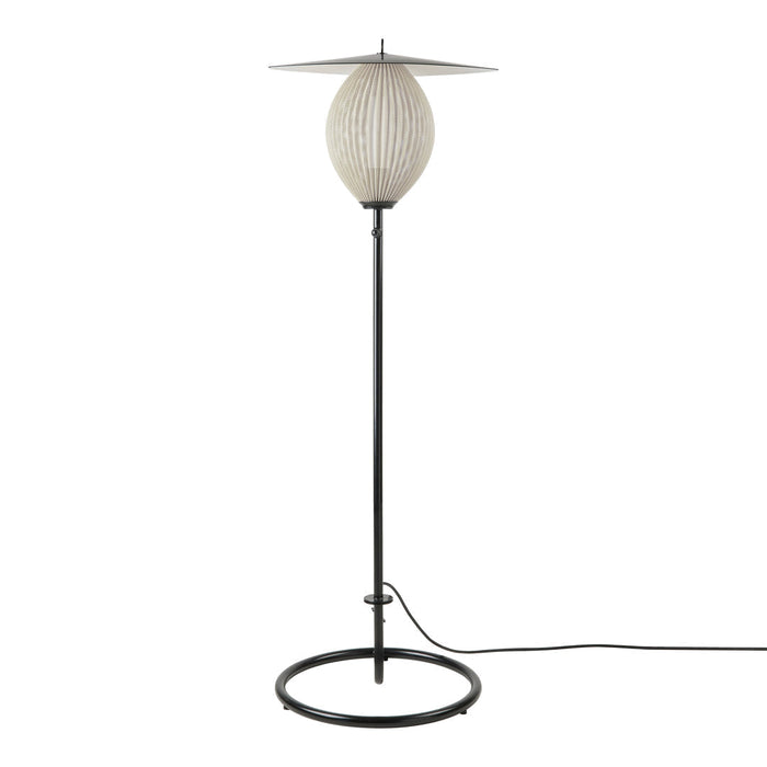 Modern floor lamp with a textured white shade and sleek black metal base, featuring a minimalist design.