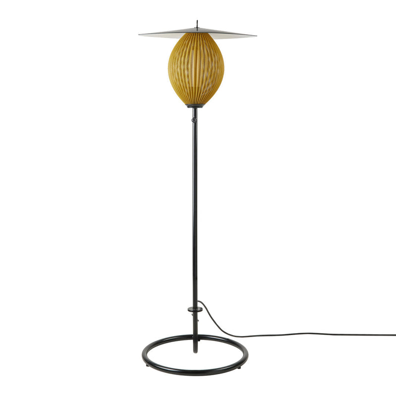 "Modern floor lamp with a textured yellow globe and sleek black metal base, featuring a minimalist design."