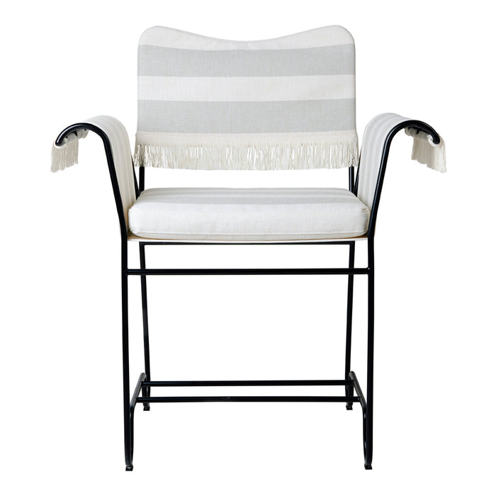 Gray and white striped chair with fringe details and a sleek black metal frame. Ideal for modern decor.