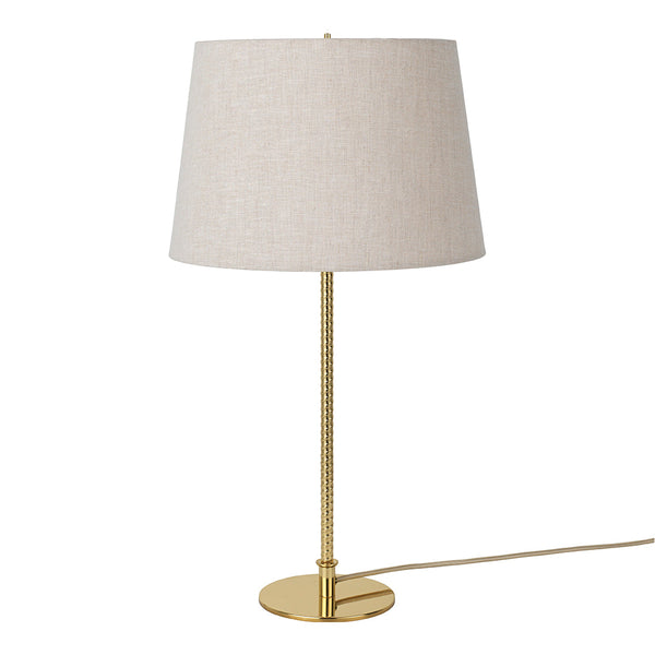 Elegant gold lamp with a textured beige fabric shade, perfect for adding a touch of sophistication to any space.