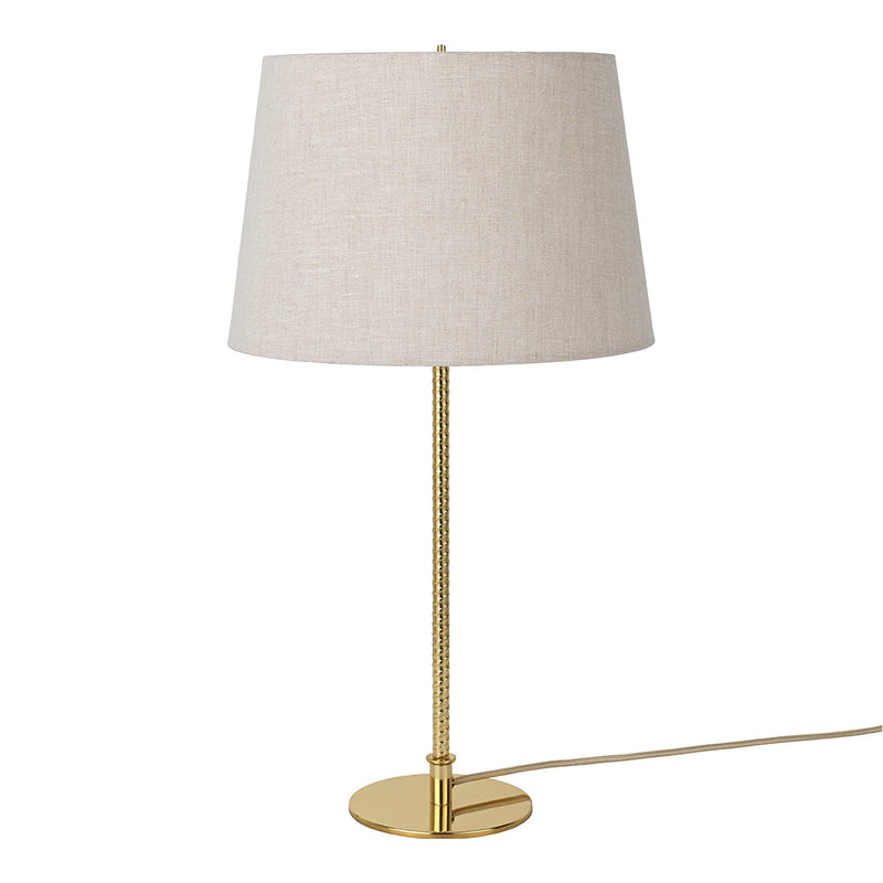 Elegant gold lamp with a textured beige fabric shade, perfect for adding a touch of sophistication to any space.