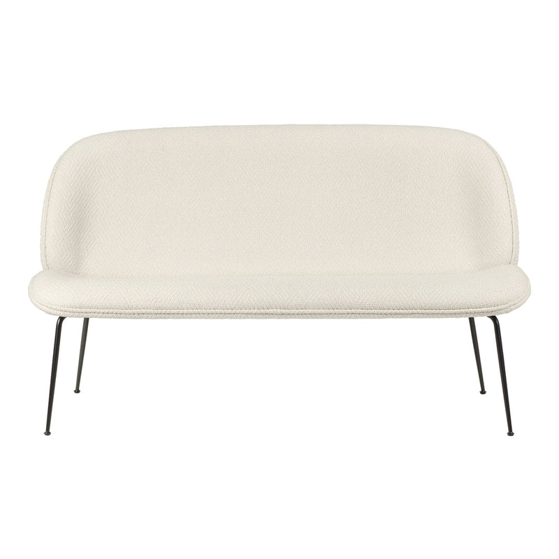Cream-colored fabric sofa with a smooth, minimalist design and sleek black metal legs. Ideal for modern decor.