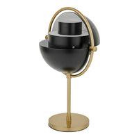 Black and gold globe-shaped table lamp with sleek, modern design and layered circular patterns.