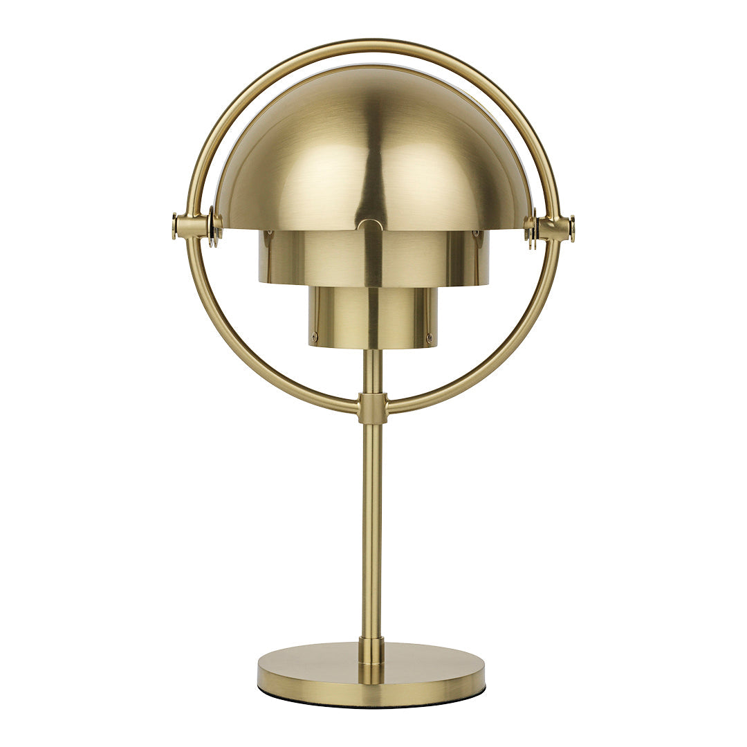 Brass desk lamp with a sleek, modern design featuring a circular base and a symmetrical dome shade.
