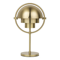 Brass desk lamp with a sleek, modern design featuring a circular base and a symmetrical dome shade.