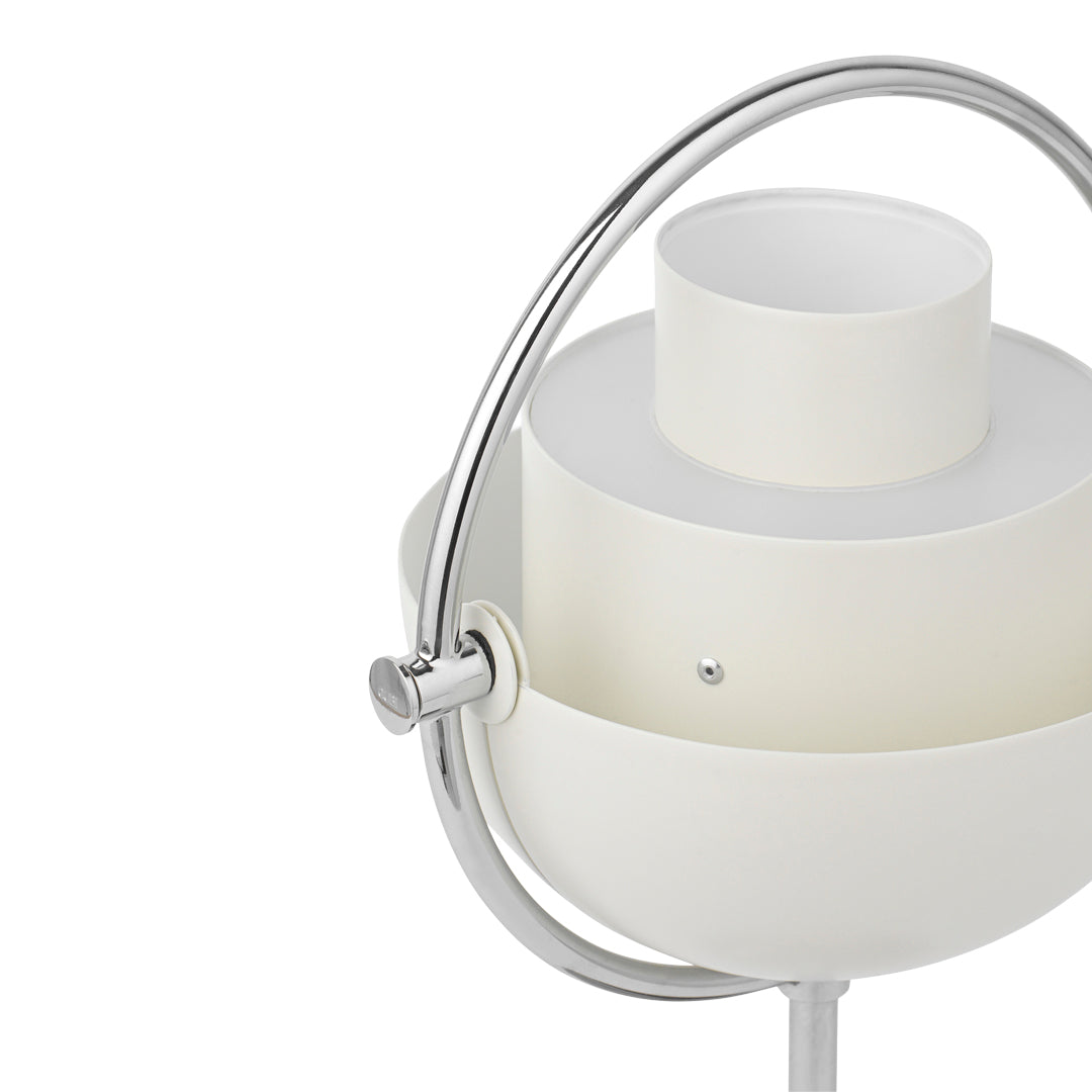 White modern lamp featuring smooth, rounded shapes and a sleek chrome handle, ideal for minimalistic decor.