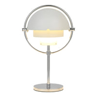 Modern chrome lamp featuring a sleek white dome shade with a soft yellow glow. Stylish and minimalist design.
