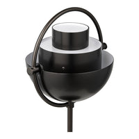 Modern black metal lamp with a sleek rounded design and white accents, featuring a minimalist geometric pattern.