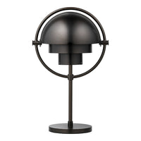 Black metal table lamp with a sleek dome shape and circular support, featuring a modern, minimalist design.
