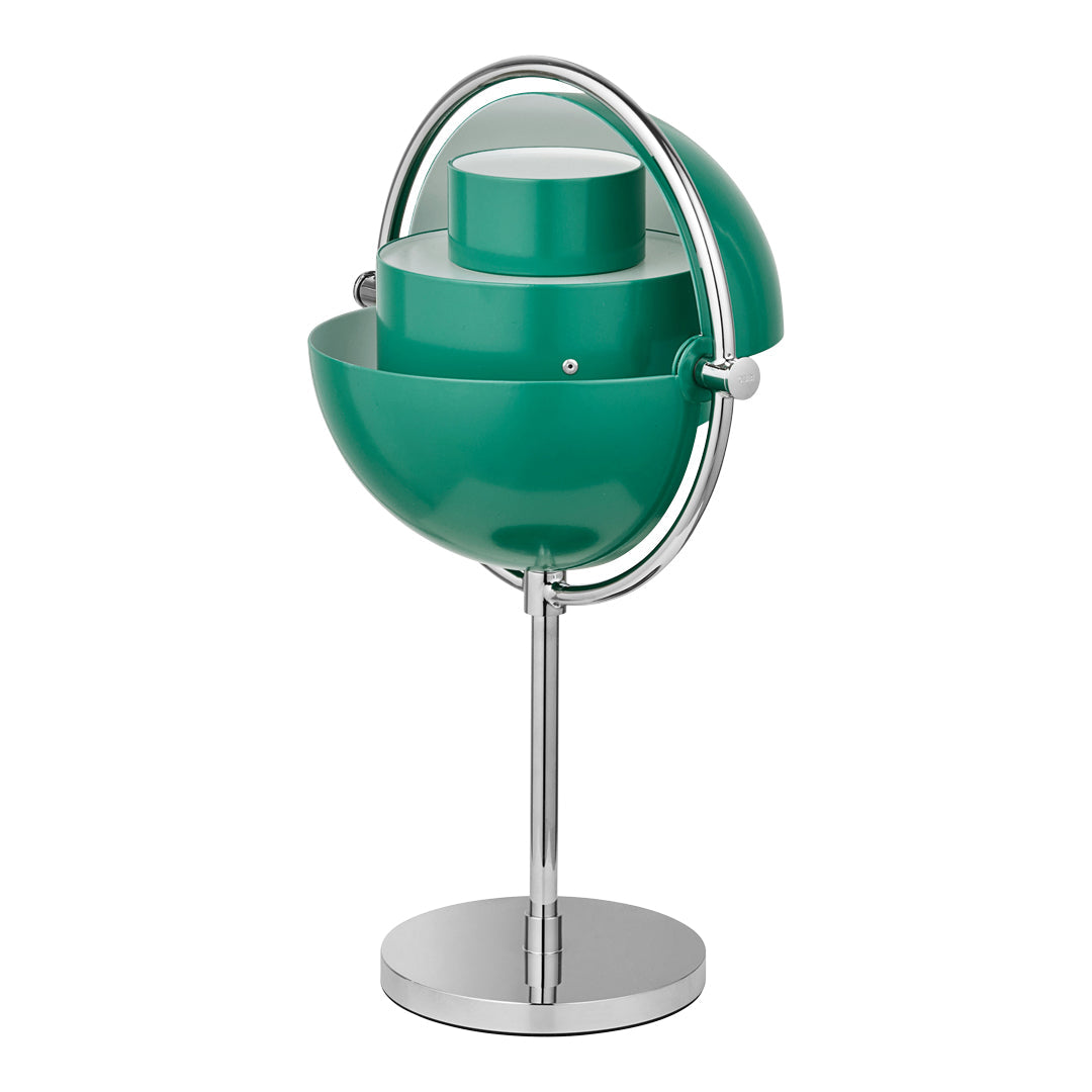 Modern table lamp in teal with a glossy finish, featuring layered circular patterns and a sleek chrome base.