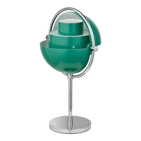 Modern table lamp in teal with a glossy finish, featuring layered circular patterns and a sleek chrome base.