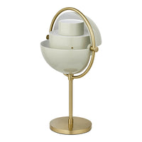 Minimalist white lamp with gold accents and a modern, spherical design, featuring smooth lines and contrasting textures.