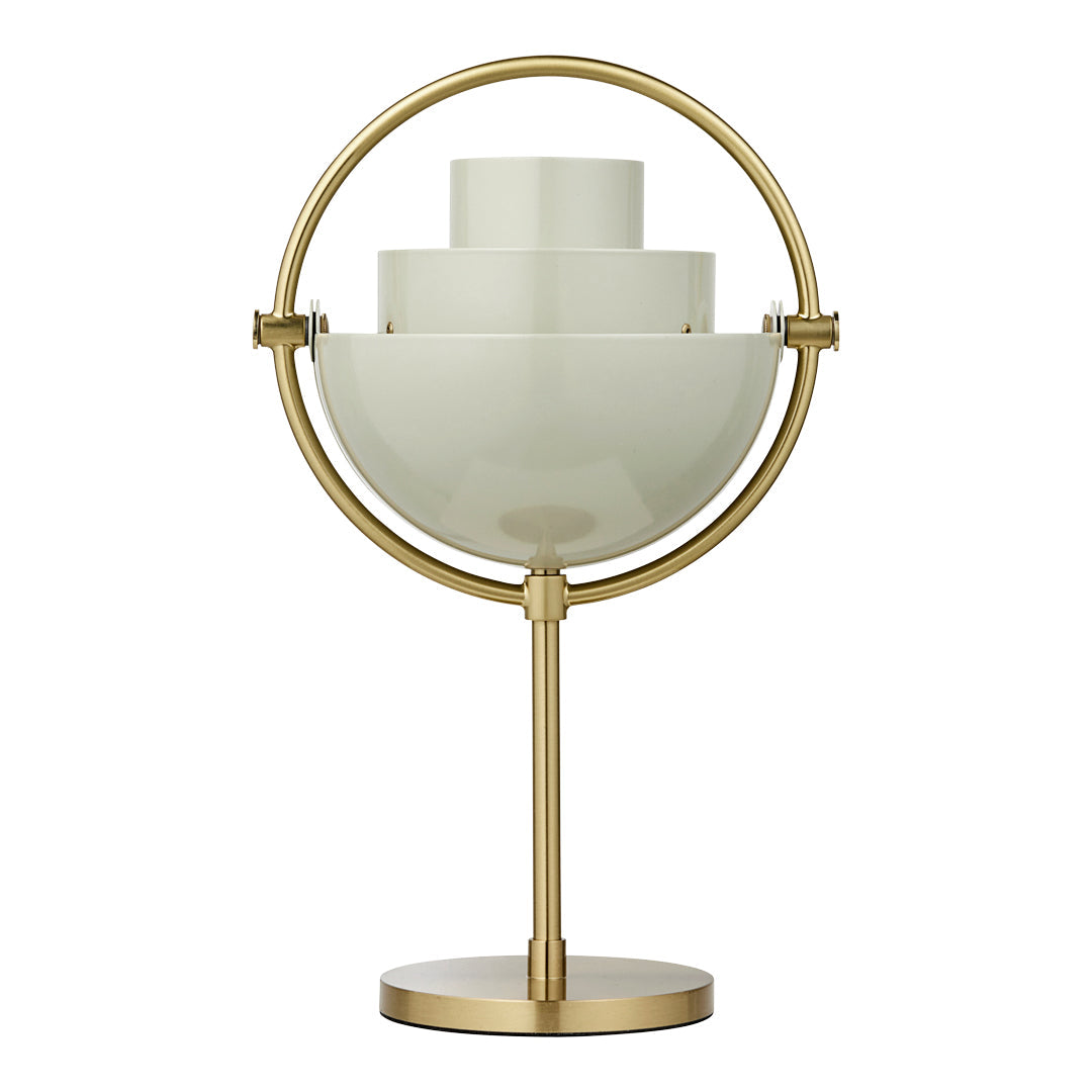 Gold table lamp with a layered, white glass design and circular base, featuring clean lines and modern aesthetic.