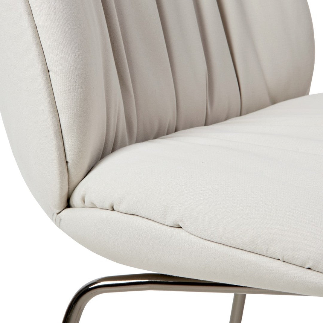 Beige upholstered chair with textured ribbed pattern and sleek chrome base. Ideal for modern decor.