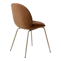 Sleek brown velvet chair with a smooth finish and gold metal legs, featuring a minimalist design. Perfect for modern decor.