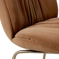 Soft brown velvet chair with plush, ribbed texture and slim metallic legs, adding a modern touch to any space.