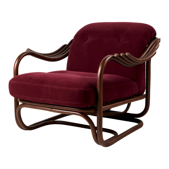 Burgundy velvet armchair with a sleek brown wood frame and curved armrests, combining elegance and comfort.