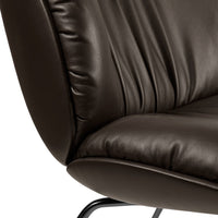 Brown leather chair with soft, textured surface and elegant draping pattern. Ideal for stylish decor.